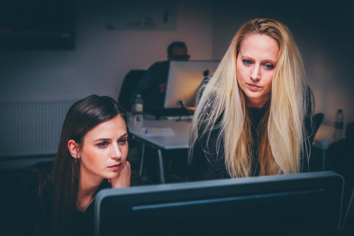 Two Women In Tech working together at a computer screen 