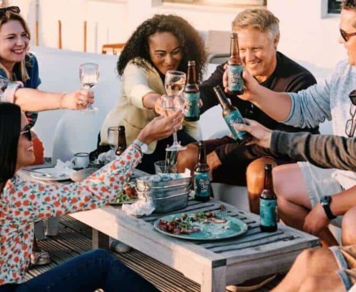 Group-of-people-al-fresco-with-drinks-saying-cheers-RESIZED1170x960
