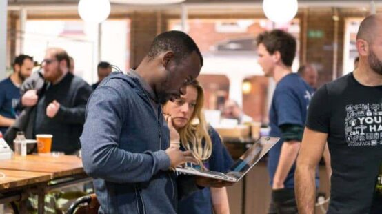 People working together on a laptop at the Hub