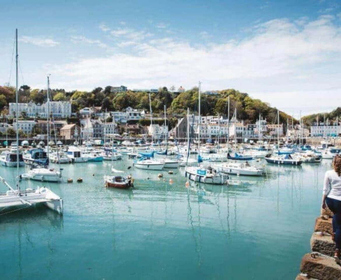 woman-walking-along-harbour-overlooking-Saint-Aubins-marinaRESIZED