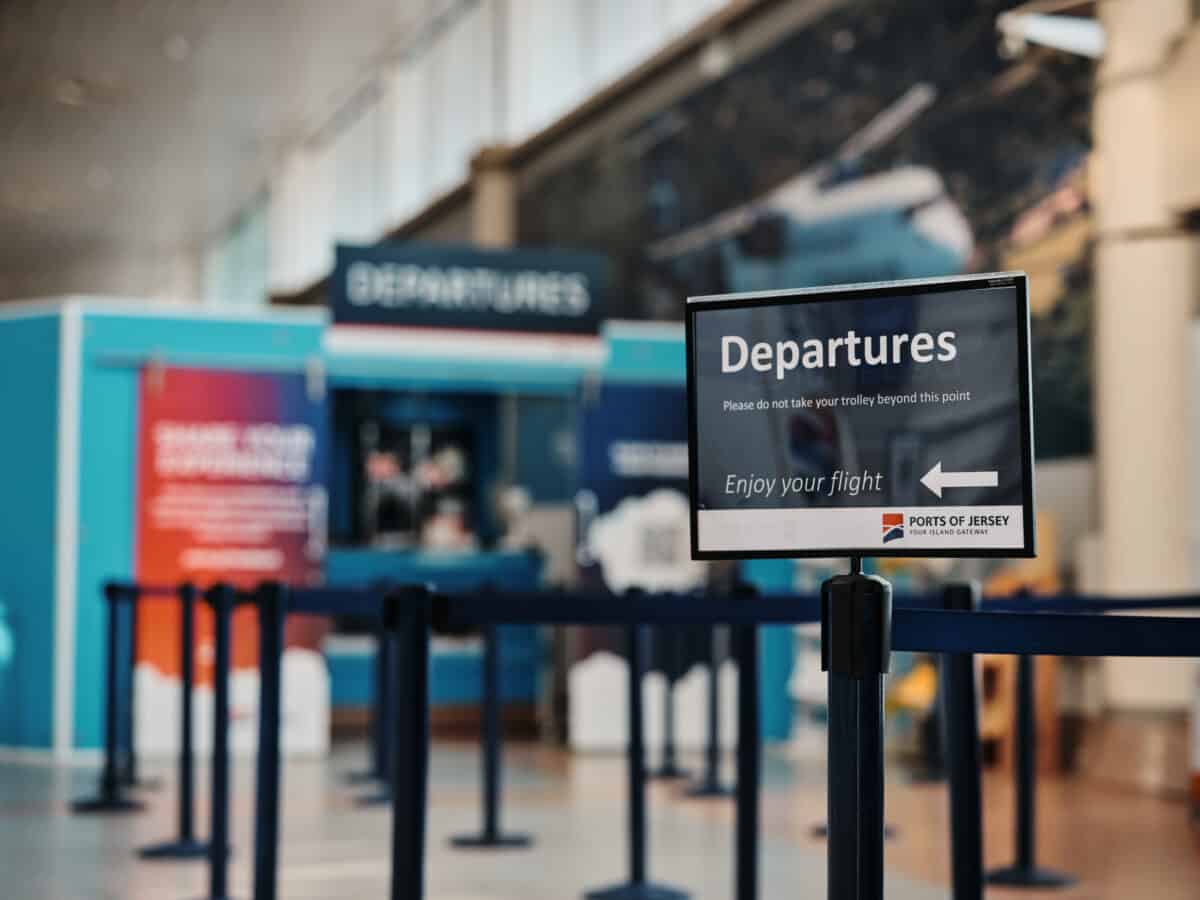 A departures sign at Jersey Airport
