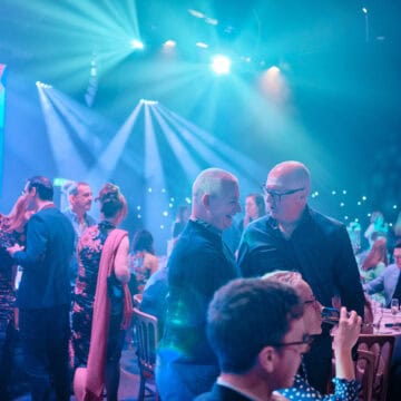 Attendees socialising at the Digital Jersey Tech Awards, with colourful lighting and a lively atmosphere