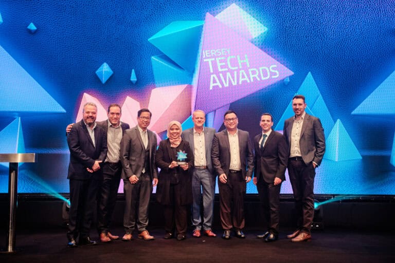Fintech Award Winner, TrustQuay Viewpoint, stood on stage with award and host Hal Cruttenden