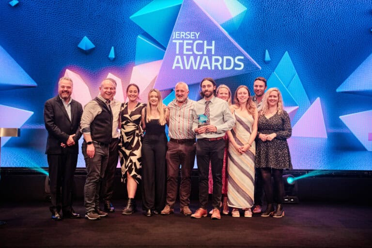 Sustainability Award Winner, Government of Jersey Marine Resources, stood on stage with award and host Hal Cruttenden
