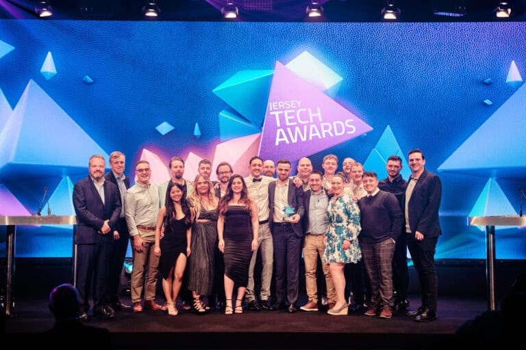 Company Award Winner, System Labs, stood on stage with award and host Hal Cruttenden