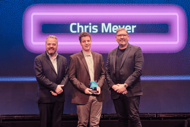 Winner of the Digital Jersey Award, Chris Meyer, stood on stage with host Hal Cruttenden