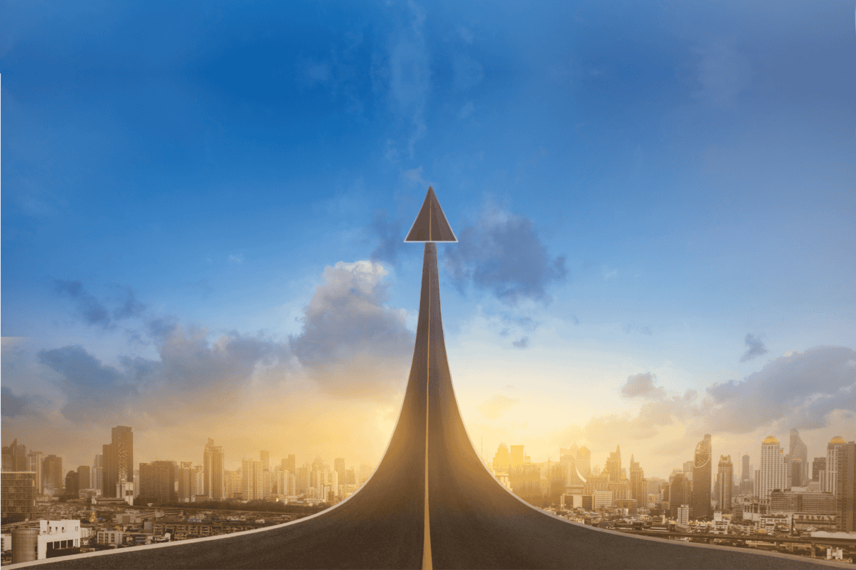 Road Leading towards the sky over a city skyline