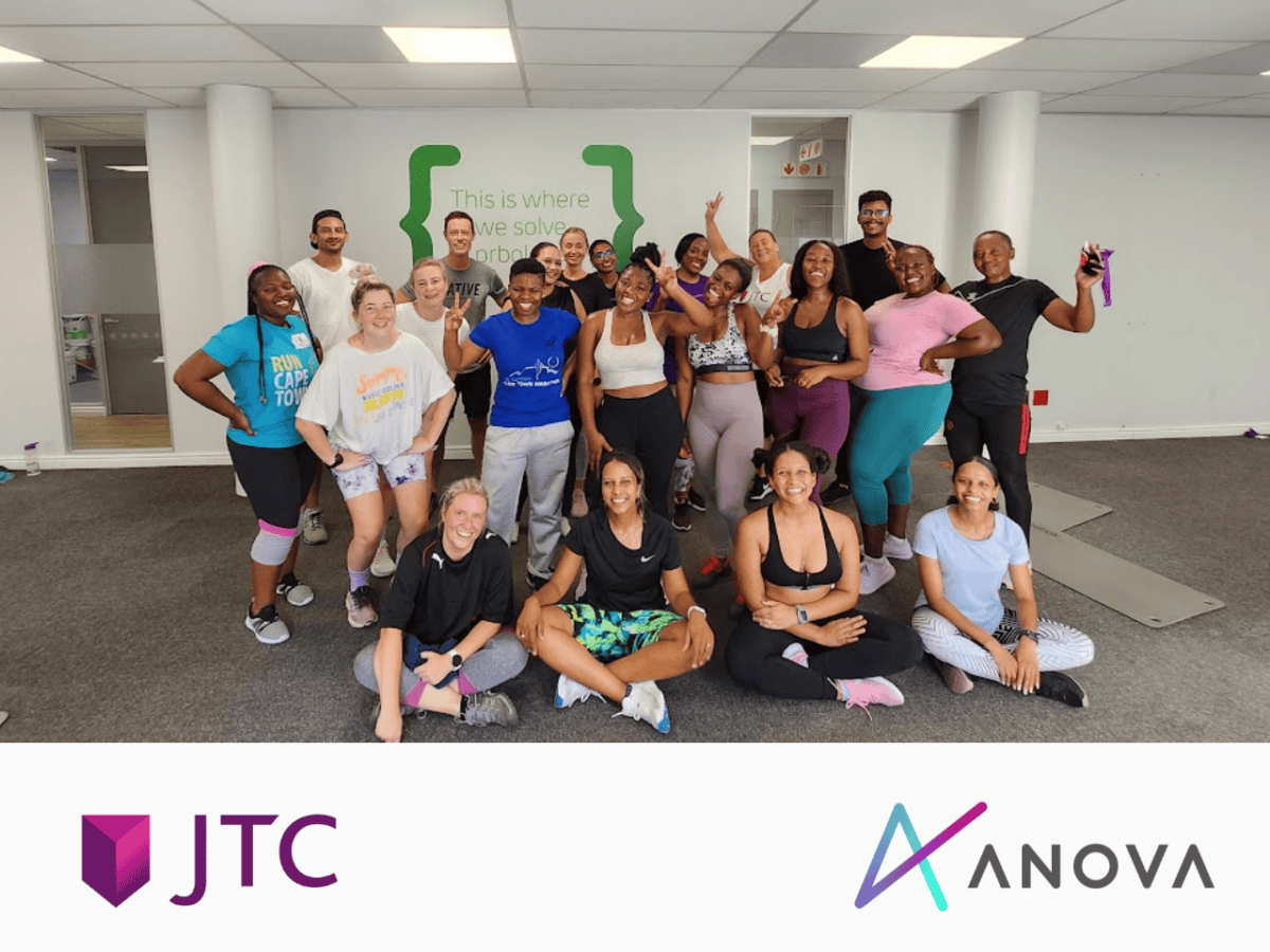 A group of JTC employees looking happy after an at-work fitness class