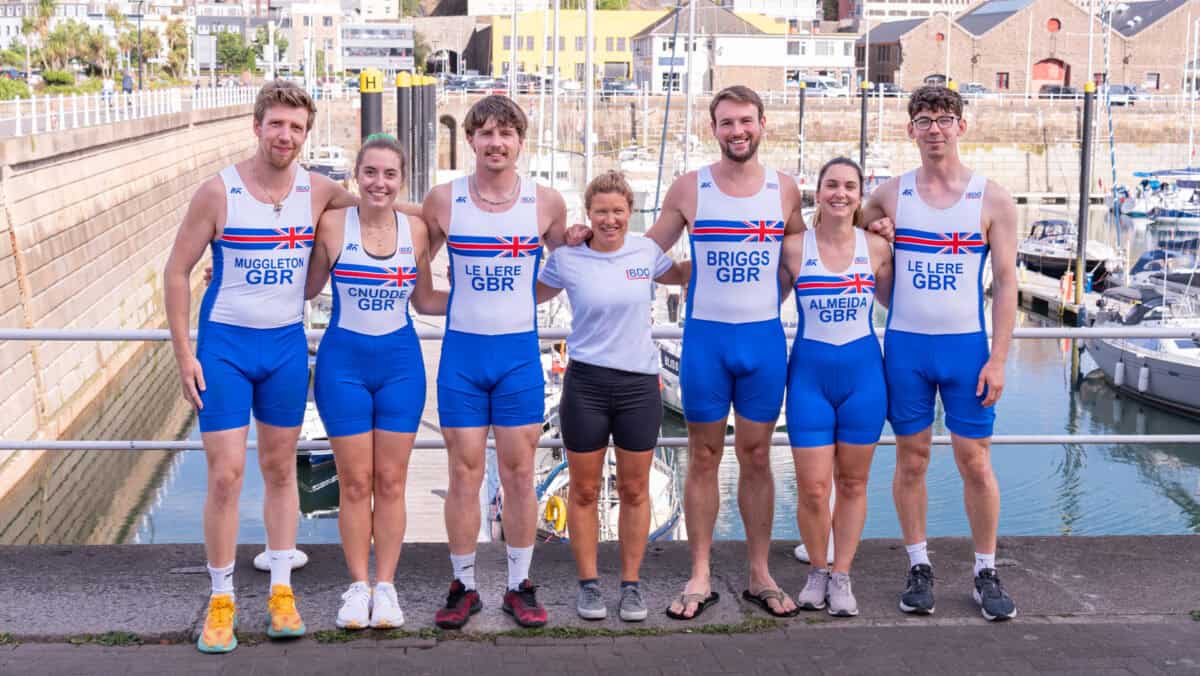 BDO representative standing with members of the Jersey Rowing Sqaud at St Helier Marina