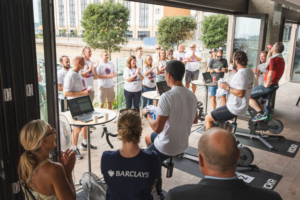 Prosperity Day is back for 2026. Prosperity 24/7’s annual charity fundraising event will once again see corporate rivals pedalling furiously to win on race day and top the leaderboard with their fundraising total. Since the first event in 2015, the event has raised over £200,000 for 20 local charities, thanks to the teams of corporate rivals who have taken part since the beginning, many of them coming back year after year. The charities set to benefit from this year’s event are Dementia Jersey and Mind Jersey. Prosperity Day will once again take place at Prosperity 24/7 's waterfront headquarters on Friday 26th June with up to 18 teams, of three cyclists in each team, going ‘head to head to head’ in a fast-paced virtual cycling challenge. Using Wahoo KICKR bikes and emulated race technology, the teams will compete against each other to gain race day points which are then added to their all-important fundraising totals. The combined scores decide who gets to top the podium.  So, while it is important how well the teams do on race day, they could still be beaten across the line, thanks to the fundraising efforts of their competitors. There are three registrations fees available, bronze, silver and gold, enabling the teams to kickstart their fundraising, depending on how ambitious they are feeling. All each team needs are three able riders and a keenness to raise as much money as possible for Dementia Jersey and Mind Jersey. Chris Clark, Prosperity’s CEO said, “This year, we are also celebrating 15 years of Prosperity 24/7 so we keen for Prosperity Day to be even more special. When we founded Prosperity 24/7, our ambition was to create a business with purpose and Prosperity Day evolved as the flagship event to capture what it means to us to make a difference to our colleagues, clients and community so we can all prosper. Mourant have been the overall winners for the last three years, so we’re excited to see if they can retain their title this year.” Dr Patricia Tumelty, Mind Jersey’s CEO, said, “ We are extremely grateful to Prosperity for supporting Mind Jersey at a time when we have clear evidence that young people are facing greater mental health problems than ever before and support for minority groups needs addressing.” Claudine Snape, Dementia Jersey’s CEO, added, “We are incredibly grateful to Prosperity 24/7 for choosing to support Dementia Jersey through this year’s Prosperity Day. We rely heavily on the support of others to continue providing vital services to islanders living with dementia and their families. We are thrilled to be part of such an inspiring event and wish all the teams the very best of luck as they pedal for two very worthwhile causes.” If you would like to find out more about the event, the charities Prosperity Day supports and to register a team for this year’s event go to https://prosperity247.com/prosperity-day/